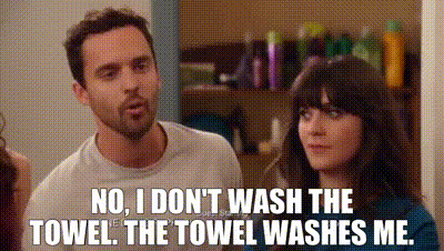 GIF of a scene from the show New Girl with Nick Miller and Jessica Day in the bathroom. Nick Miller is saying "No I don't wash the towel. The towel washes me."